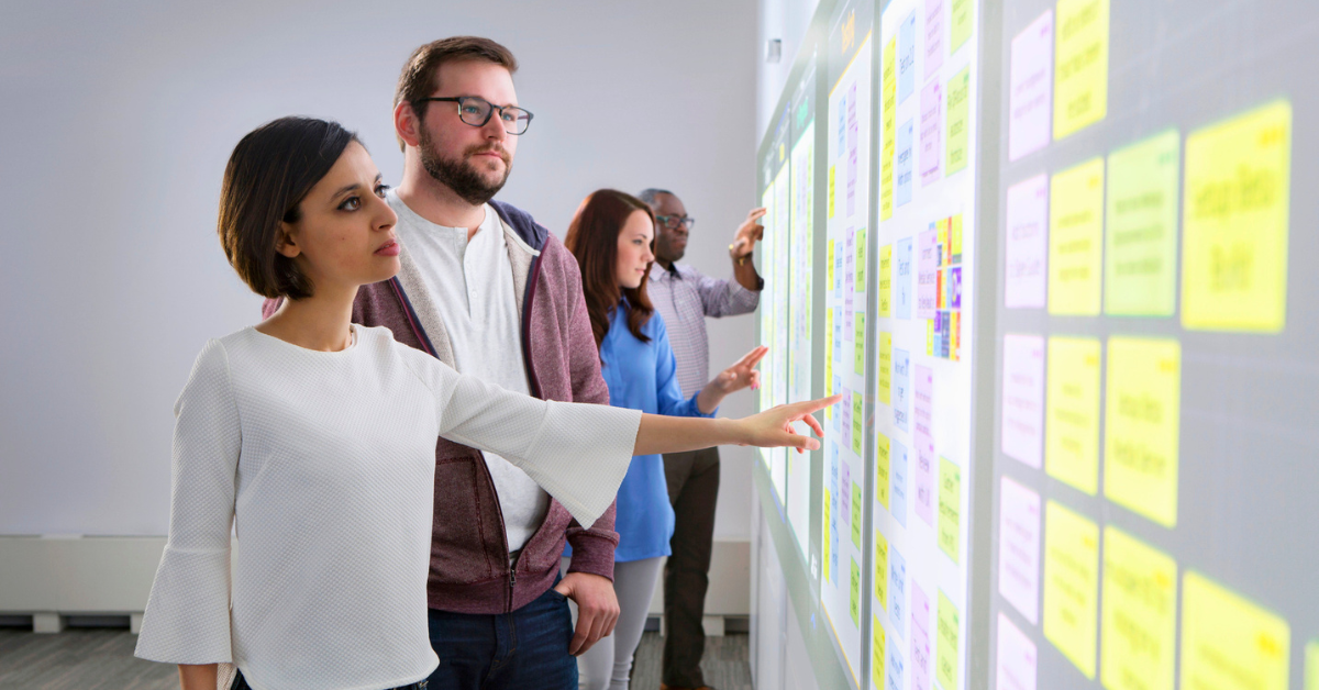 A team collaborates using an interactive projector wall