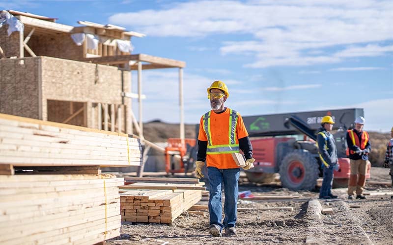 Construction worker walks jobsite - lean construction blog