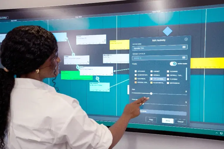 Simple to master in minutes - a user interacts with Nialli Visual Planner using a touch display.